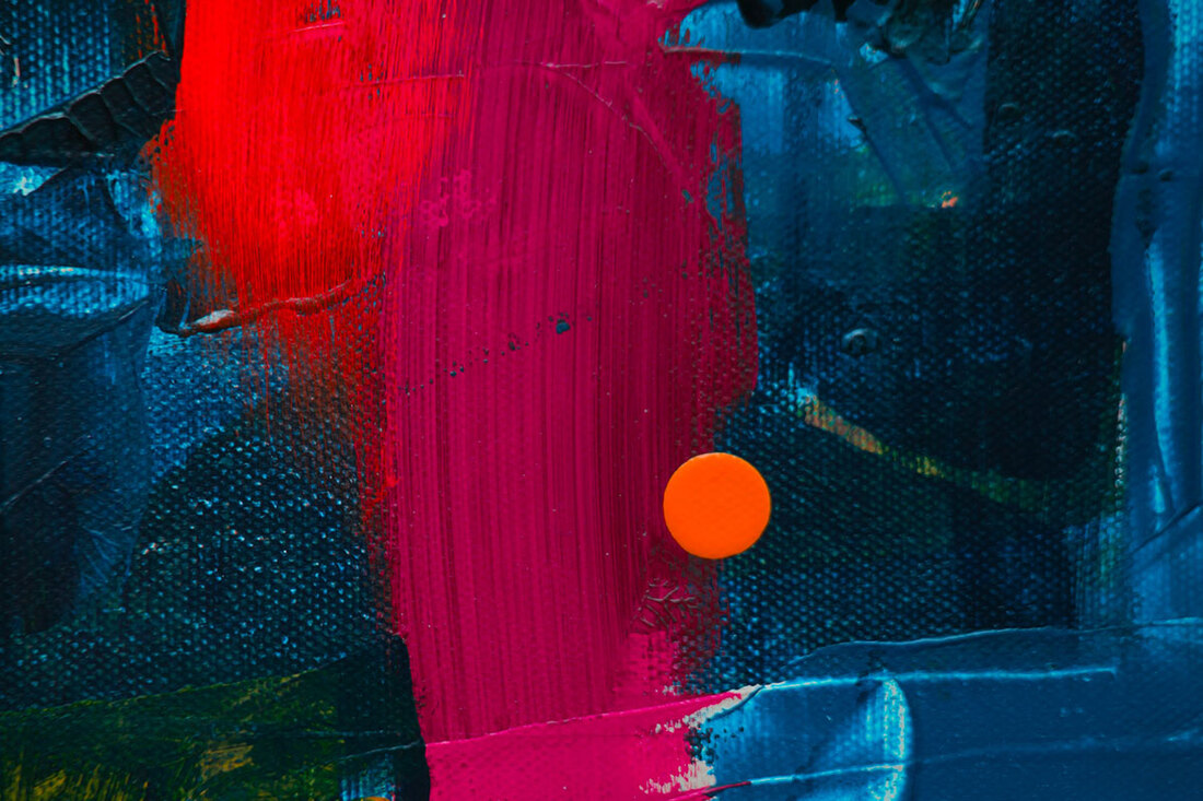 Abstract art. Mostly blue canvas with streaks of red and pink and an orange circle