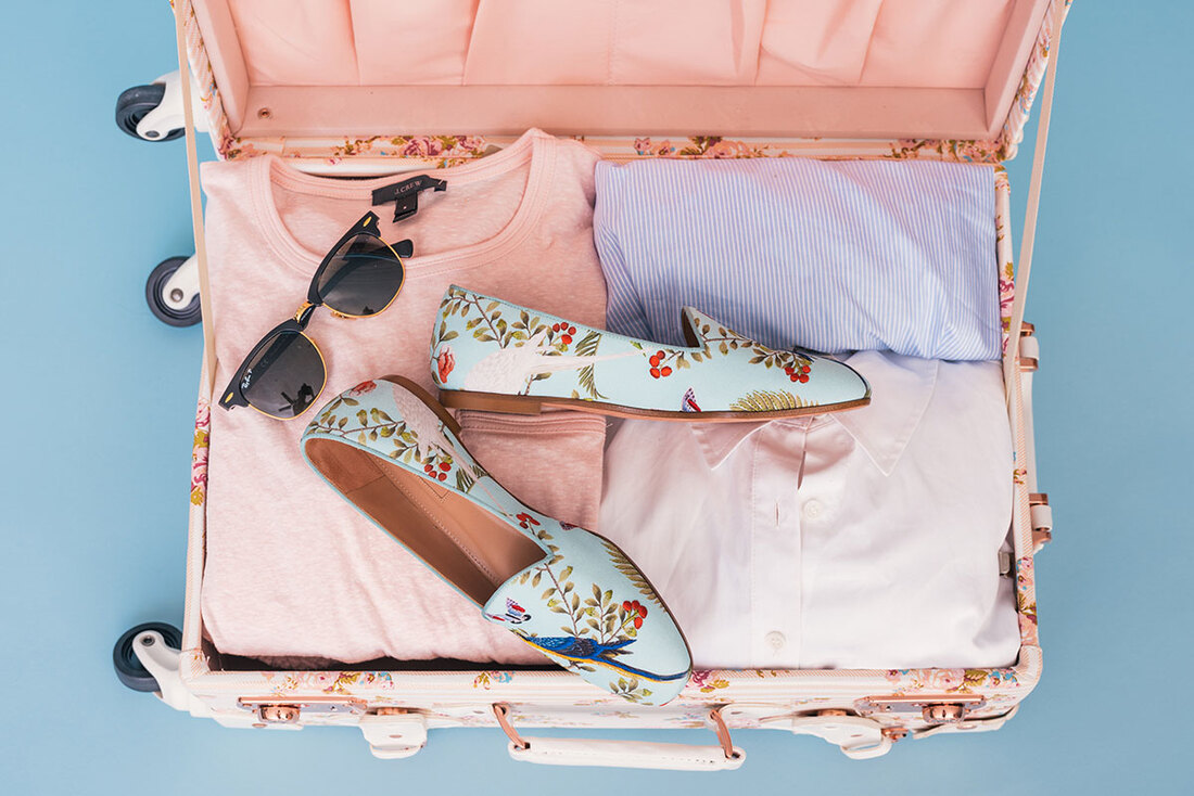 pink suitcase with neatly packed clothing