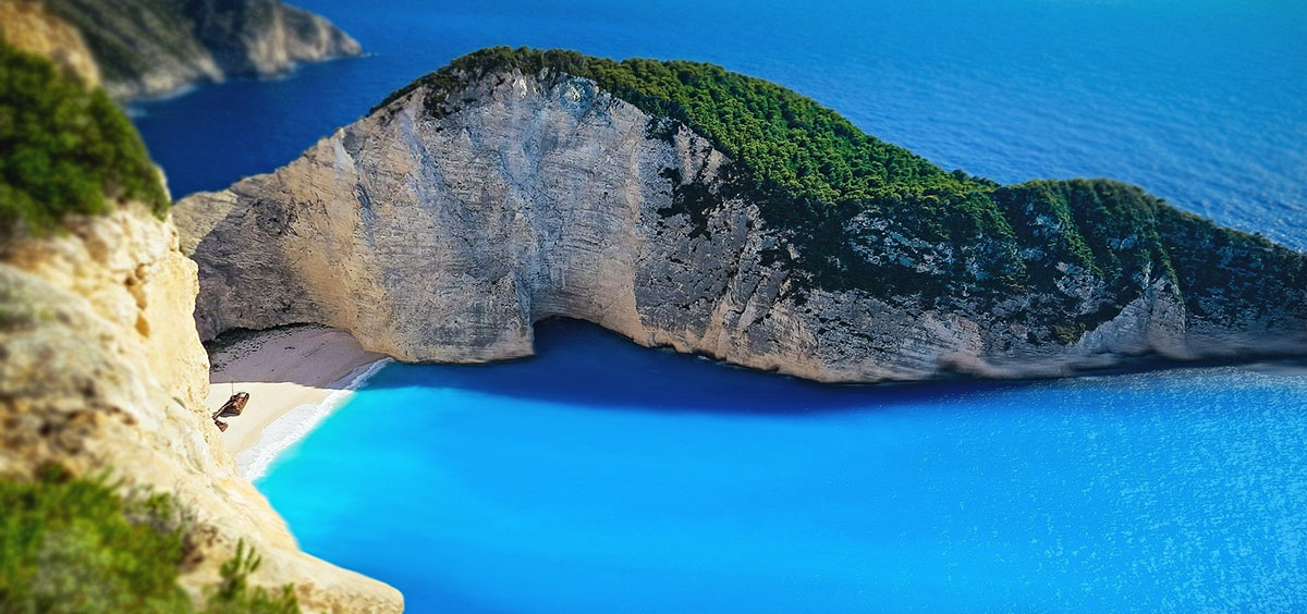cliffs next to a bright blue sea in Greece