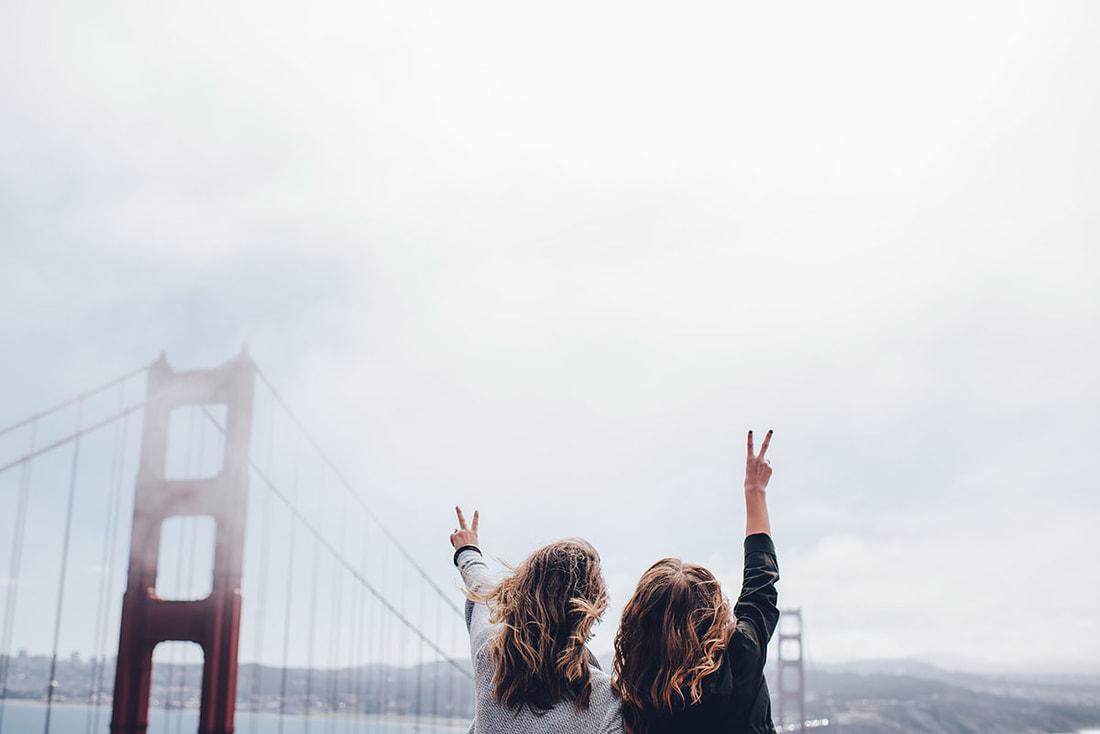 two women in front of the Golden Gate Bridge in San Francisco 
